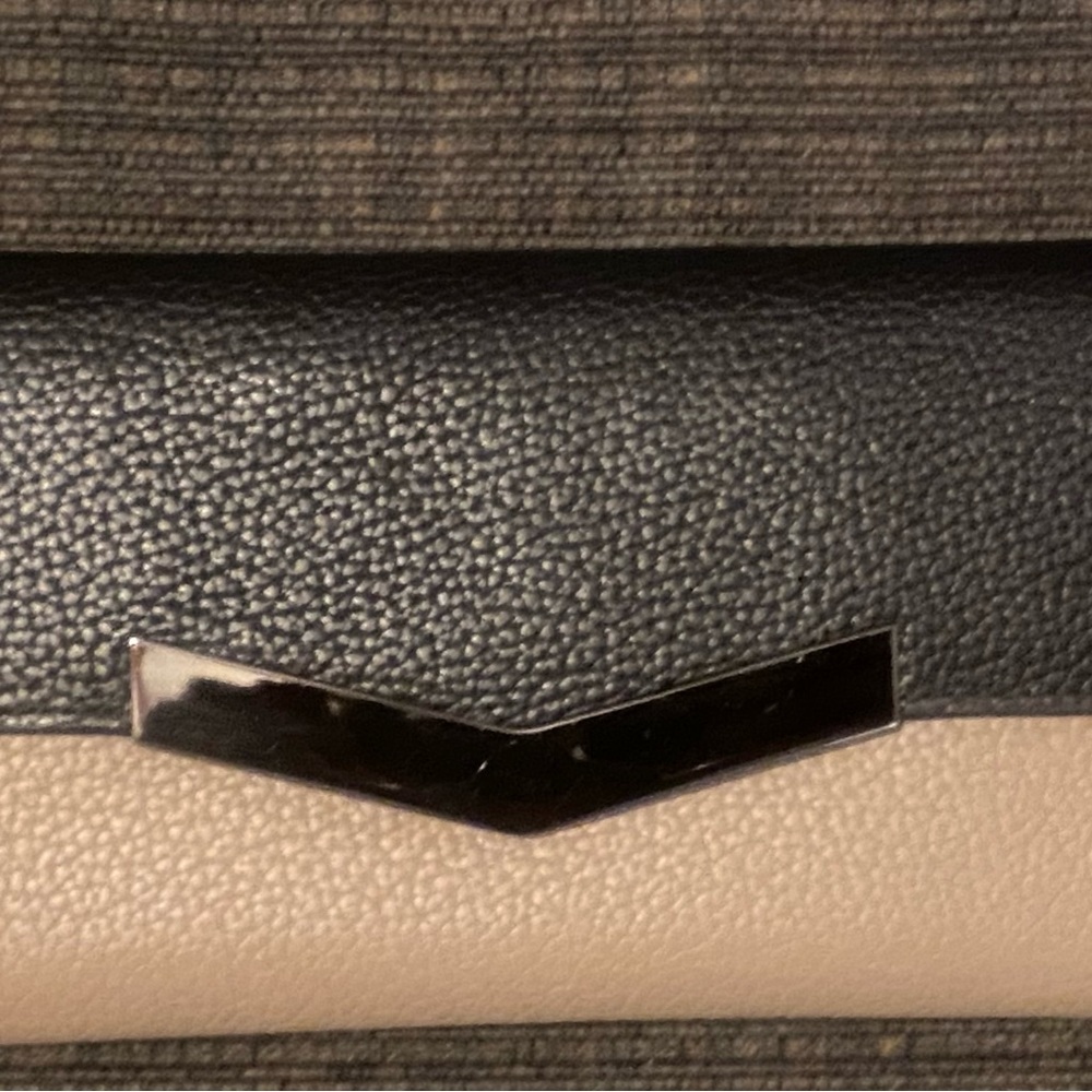 Sophisticated Black and Cream Wallet with Modern Metallic Accent